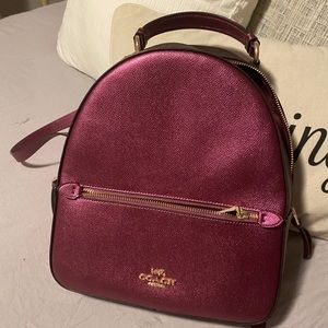 Coach back pack. Metallic berry color.
